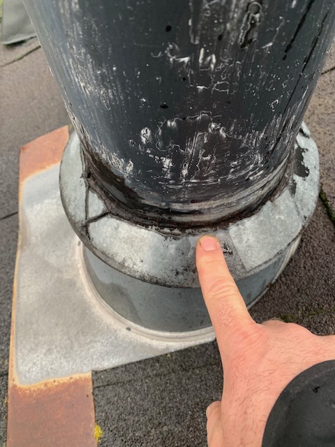 Roof with missing caulking around chimney pipe