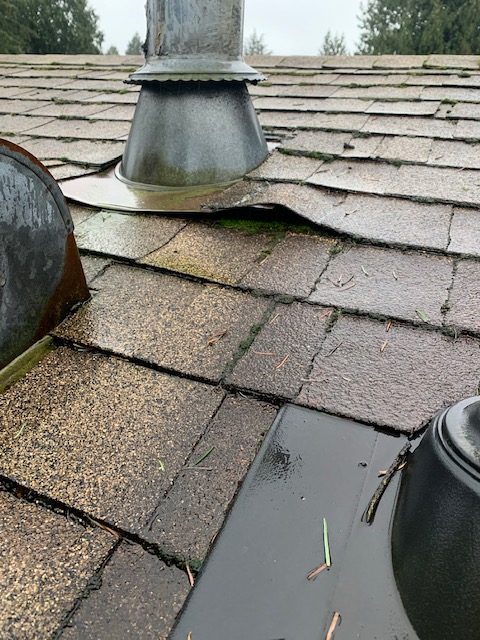 Roof with broken caulking around chimney pipe